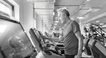 A man exercising on a treadmill in a gym